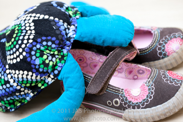 cute stuffed sea turtle trying to climg into shoes