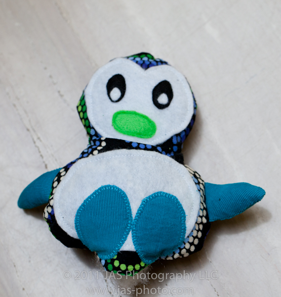 stuffed penguin toy before opening is closed