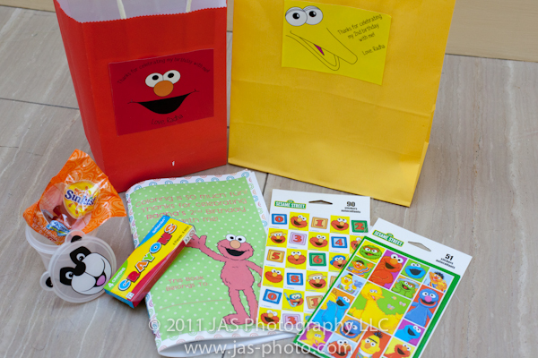 gift bag ideas for sesame street elmo party theme with coloring book, stickers, and fruit snacks